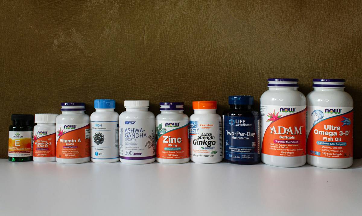 Probiotics gummies for digestive health on a wooden table with fresh fruits and water